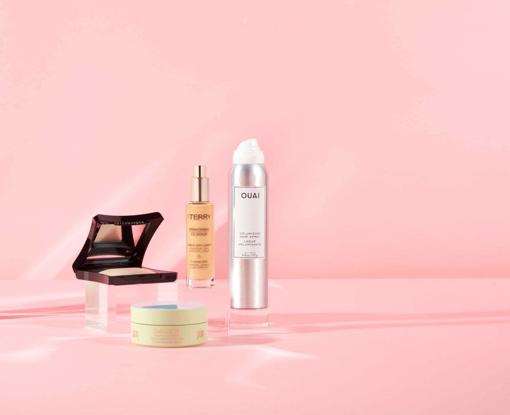 Beauty products on pink background displayed for a photoshoot