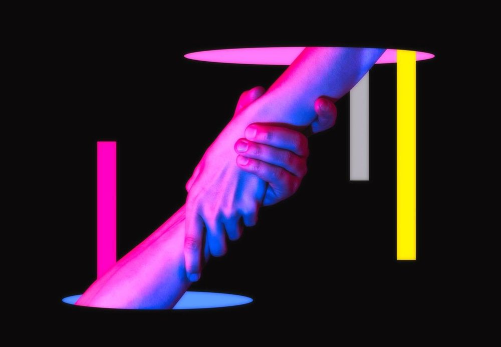 hands interlocking in blue and magenta light on black background
