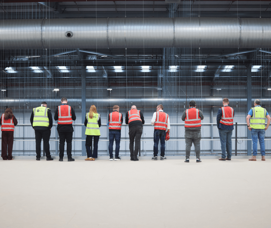 people standing in thg fulfil warehouse