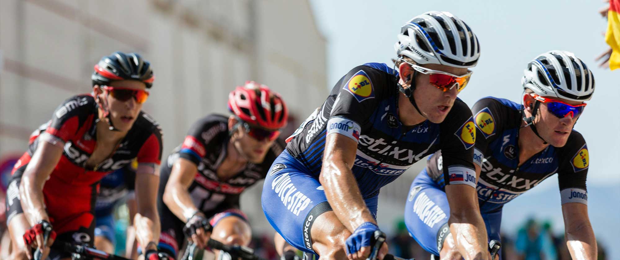 Cyclists racing outdoors, showing demand for sweat-resistant SPF formats in endurance sports. (header image)