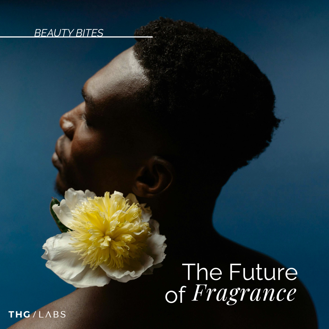 Man holding flower under chin representing expressive scent.