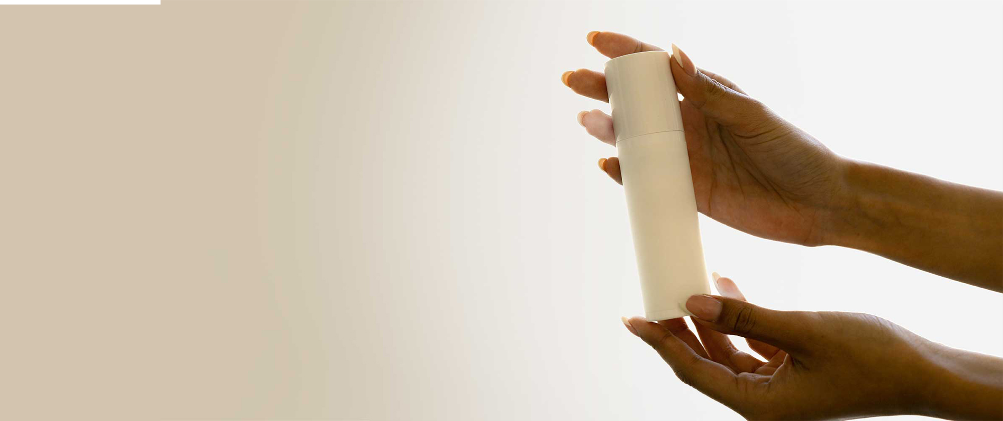 Premium haircare product packaging held in hand, representing science-led formulation development, product innovation and beauty manufacturing expertise.