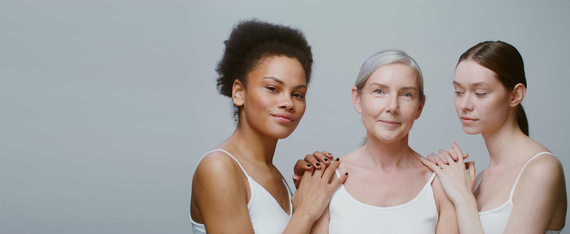 Three women of different ages symbolising cross-generational skincare innovation and longevity-focused cosmetic manufacturing