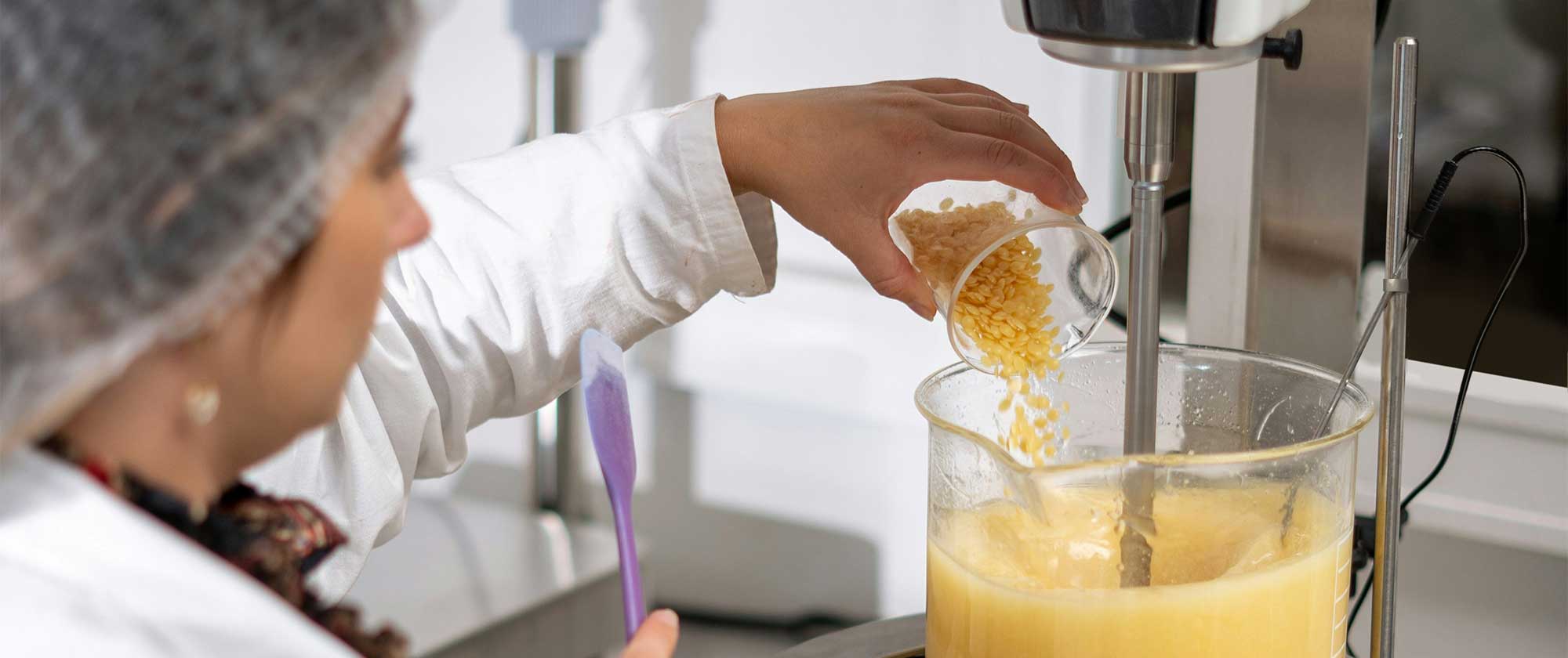 : Cosmetic scientist compounding a beauty formulation during early-stage product development and scale-up planning