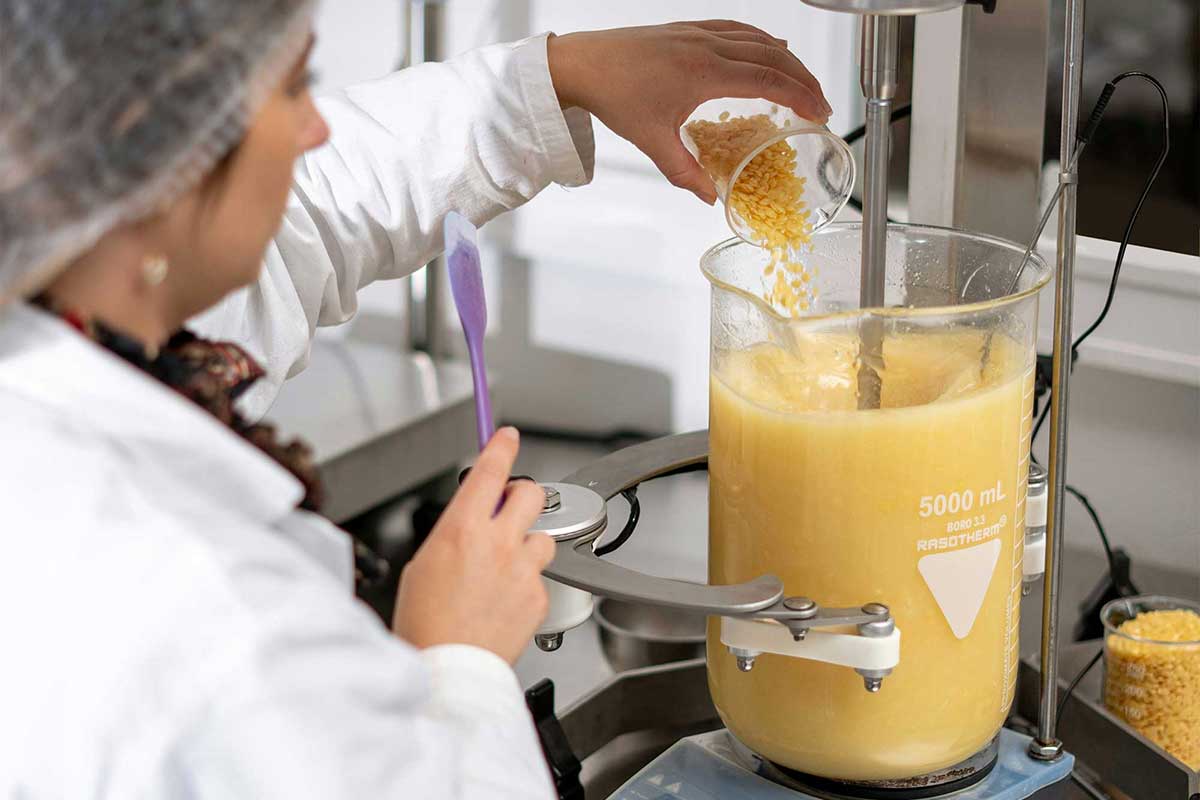 : Cosmetic scientist compounding a beauty formulation during early-stage product development and scale-up planning
