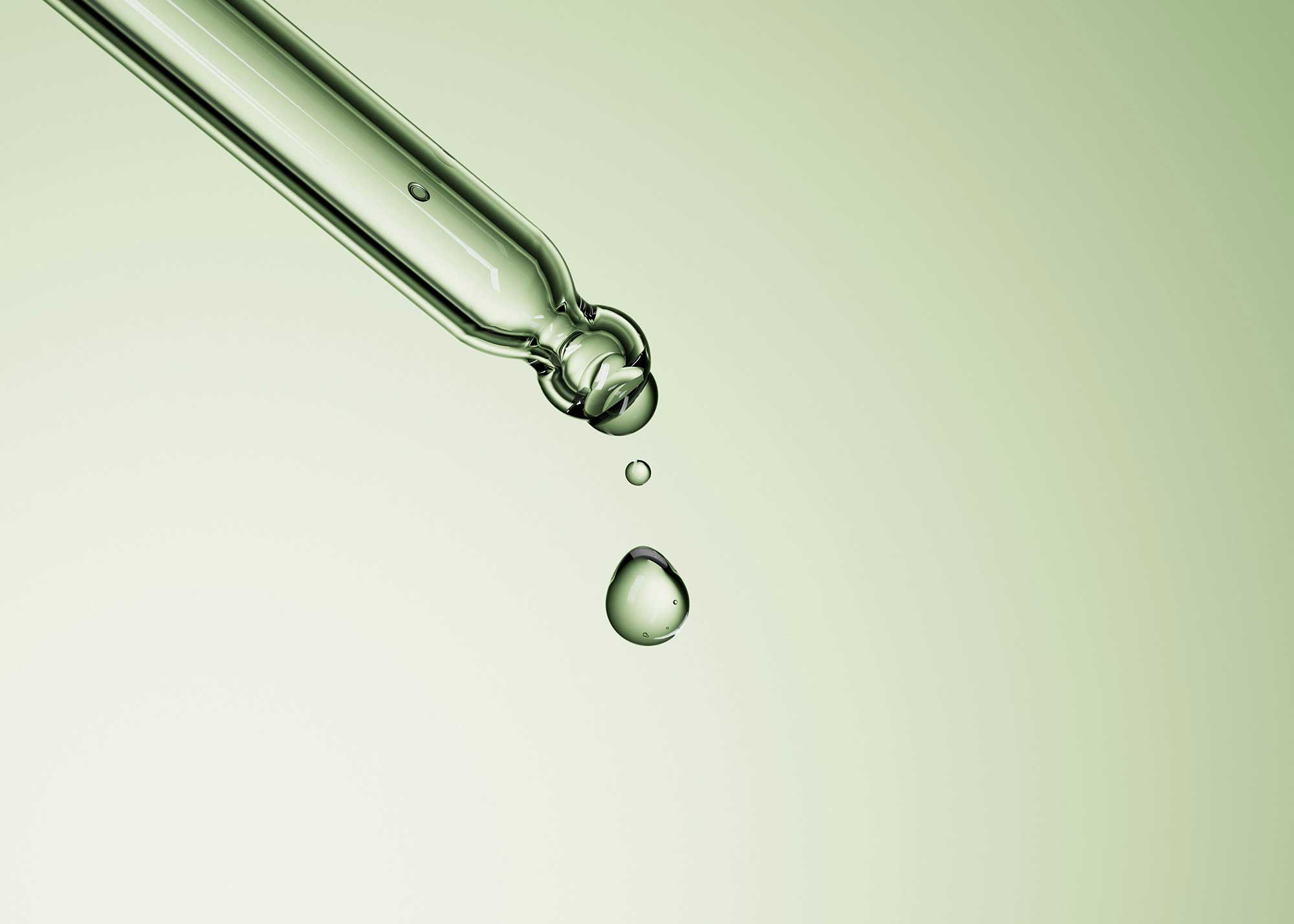 Close-up cosmetic serum pipette dispensing skincare formulation, representing precision beauty manufacturing, active ingredient delivery and biotech skincare innovation by THG LABS.