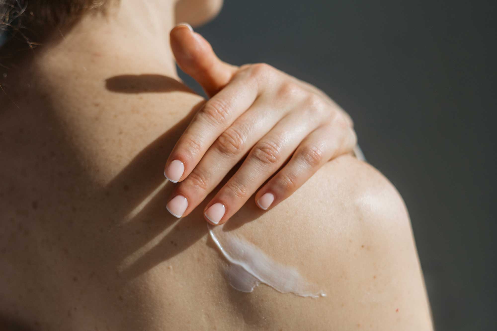Close-up of body care product being applied to the shoulder, illustrating THG LABS targeted body care formulation  and skincare-led product innovation.