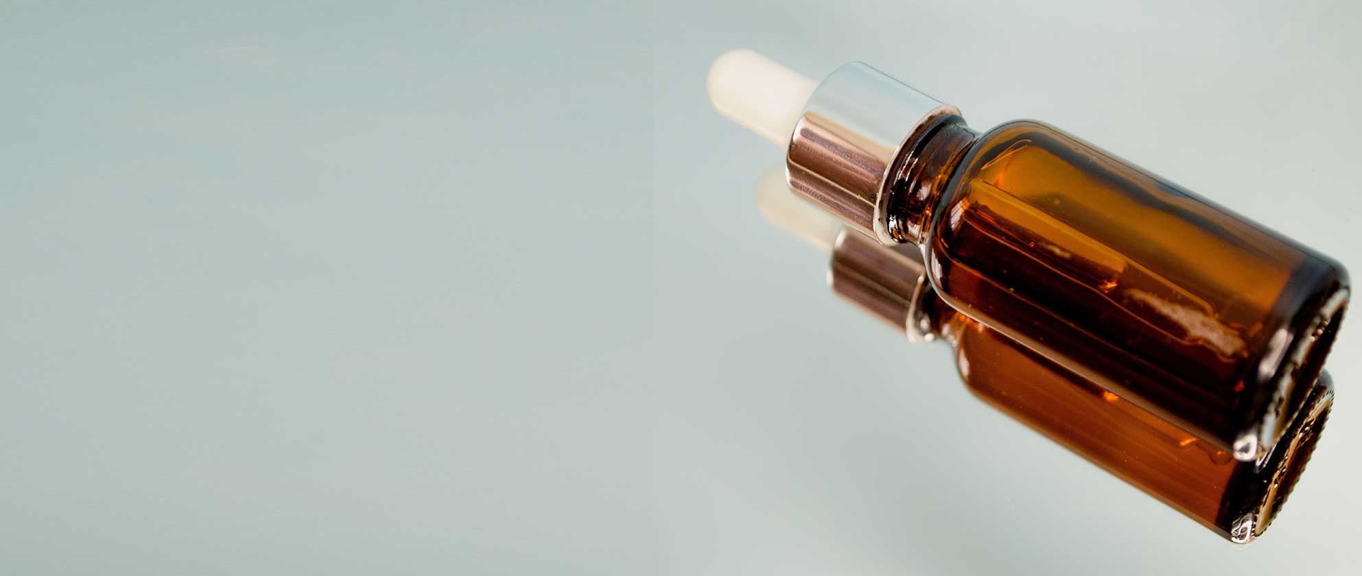 Amber cosmetic dropper bottle representing established beauty products being transferred to a new manufacturing partner.