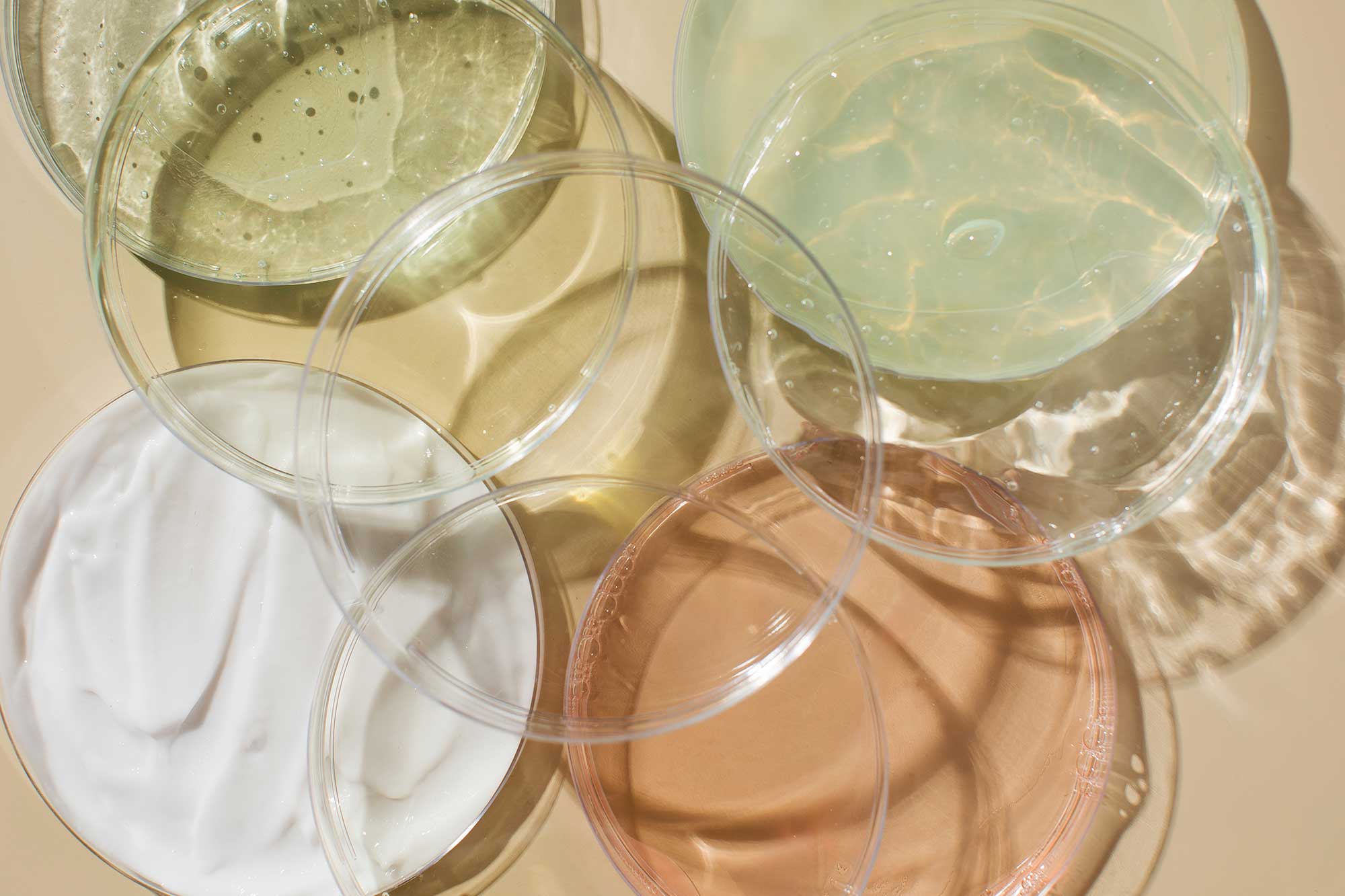 Cream and gel textures in sample dishes, illustrating the development of bespoke body care formulations with tailored sensory properties.