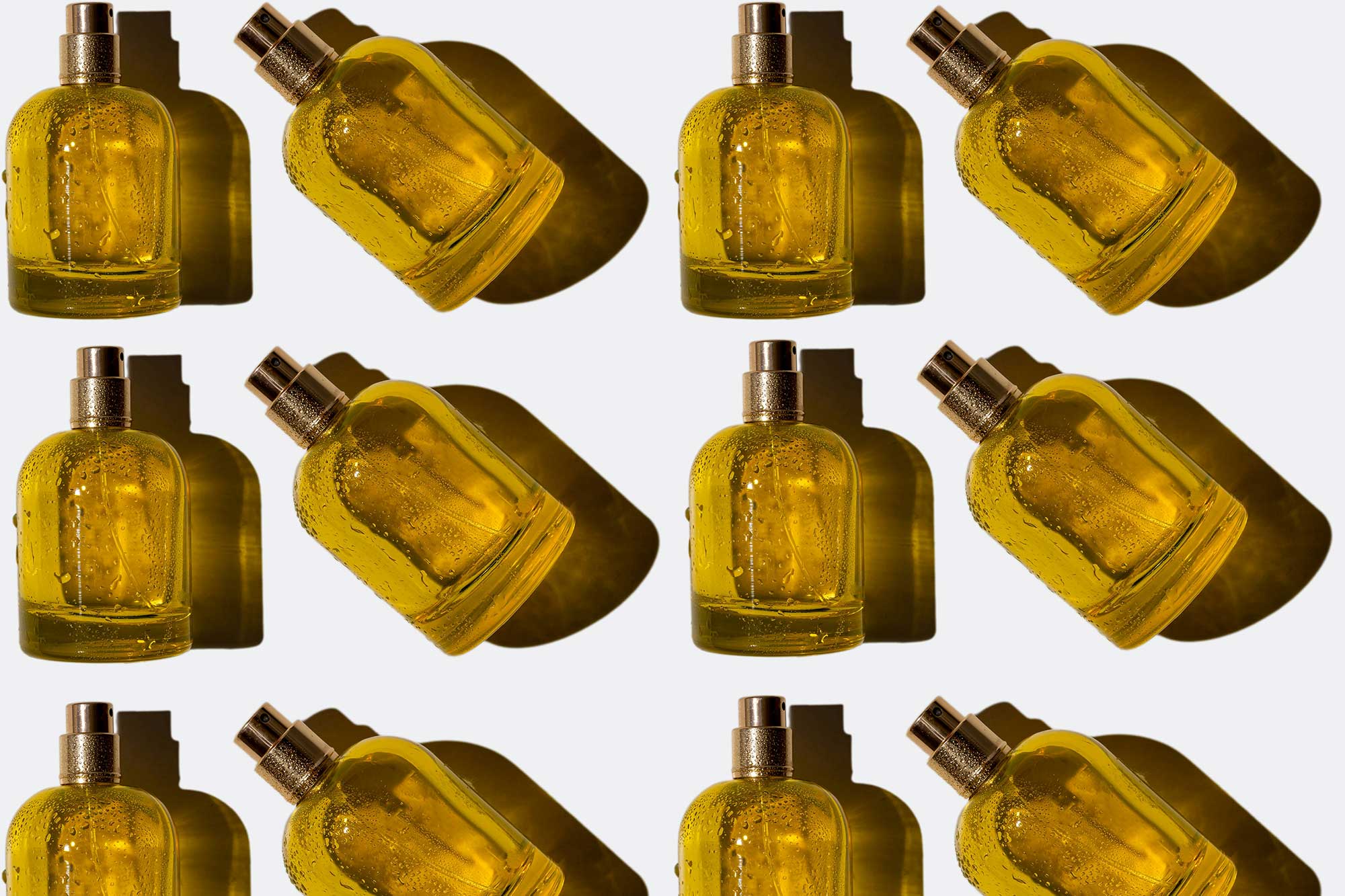 Repeated golden cosmetic spray bottles representing scalable beauty manufacturing with THG LABS full-service beauty manufacturers.