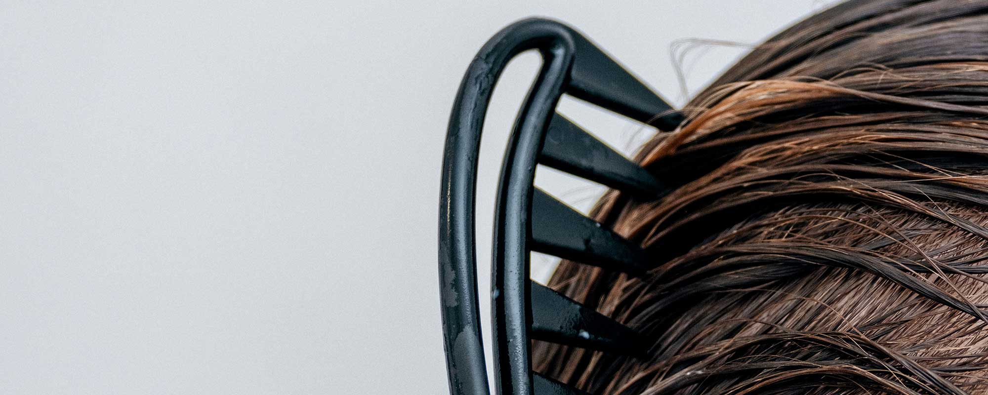 Consumer applying a scalp-focused haircare treatment as part of a multi-step wellness-led haircare ritual, reflecting premium haircare product development trends explored by THG LABS.