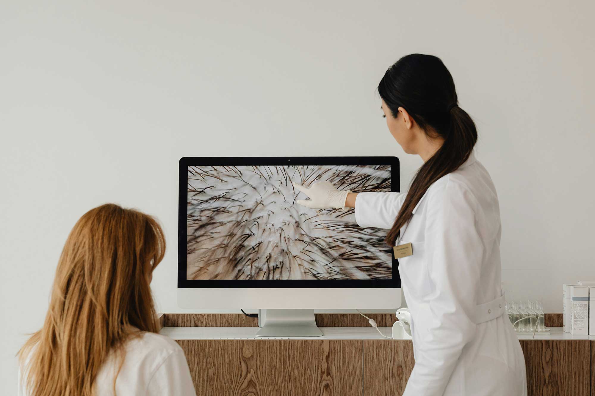 Hair and scalp diagnostic consultation demonstrating precision-led haircare innovation, personalised scalp analysis and performance-focused product development in modern haircare manufacturing at THG LABS.