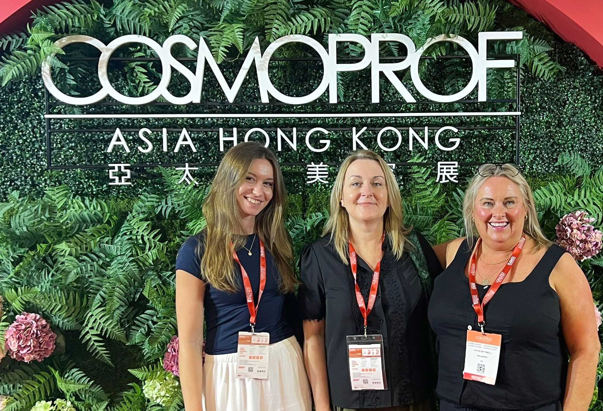 THG LABS colleagues in front of the floral Cosmoprof Asia event backdrop