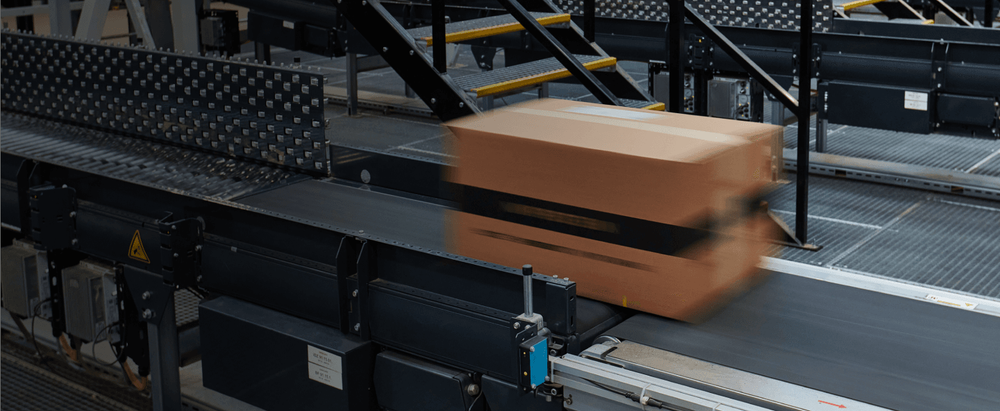 Delivery line conveyor belt handling a MyProtein parcel